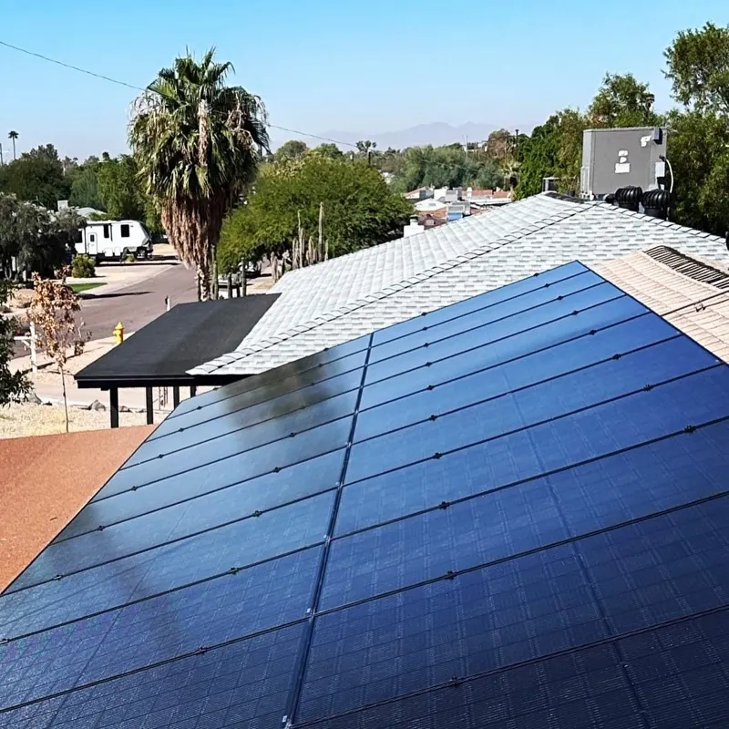 Rooftop solar on a tile roof beside a palm in Arizona