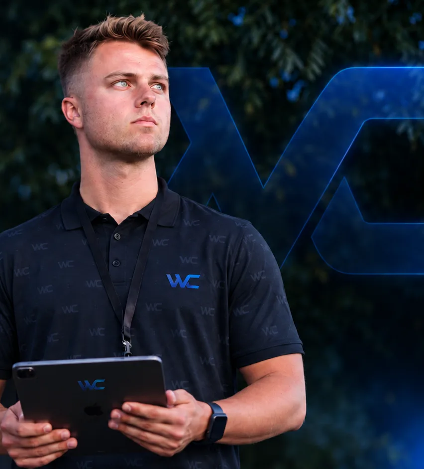 A Wood Consulting rep in the WC polo, tablet in hand, outside a customer's home