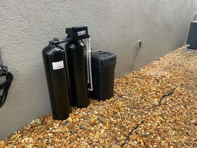 Dual tank whole-home water system installed beside a Florida home