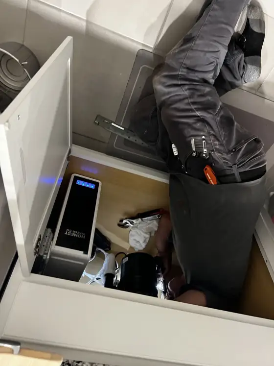 Technician completing an under-sink installation
